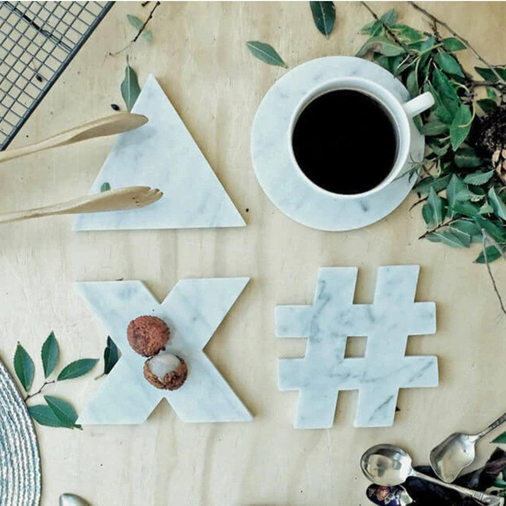 Carrara White genuine marble triangle round hastag x coasters 5x5 polished set of 4 SKU-MSBCRGEU5x5SP product shot  top view with a cup of coffee