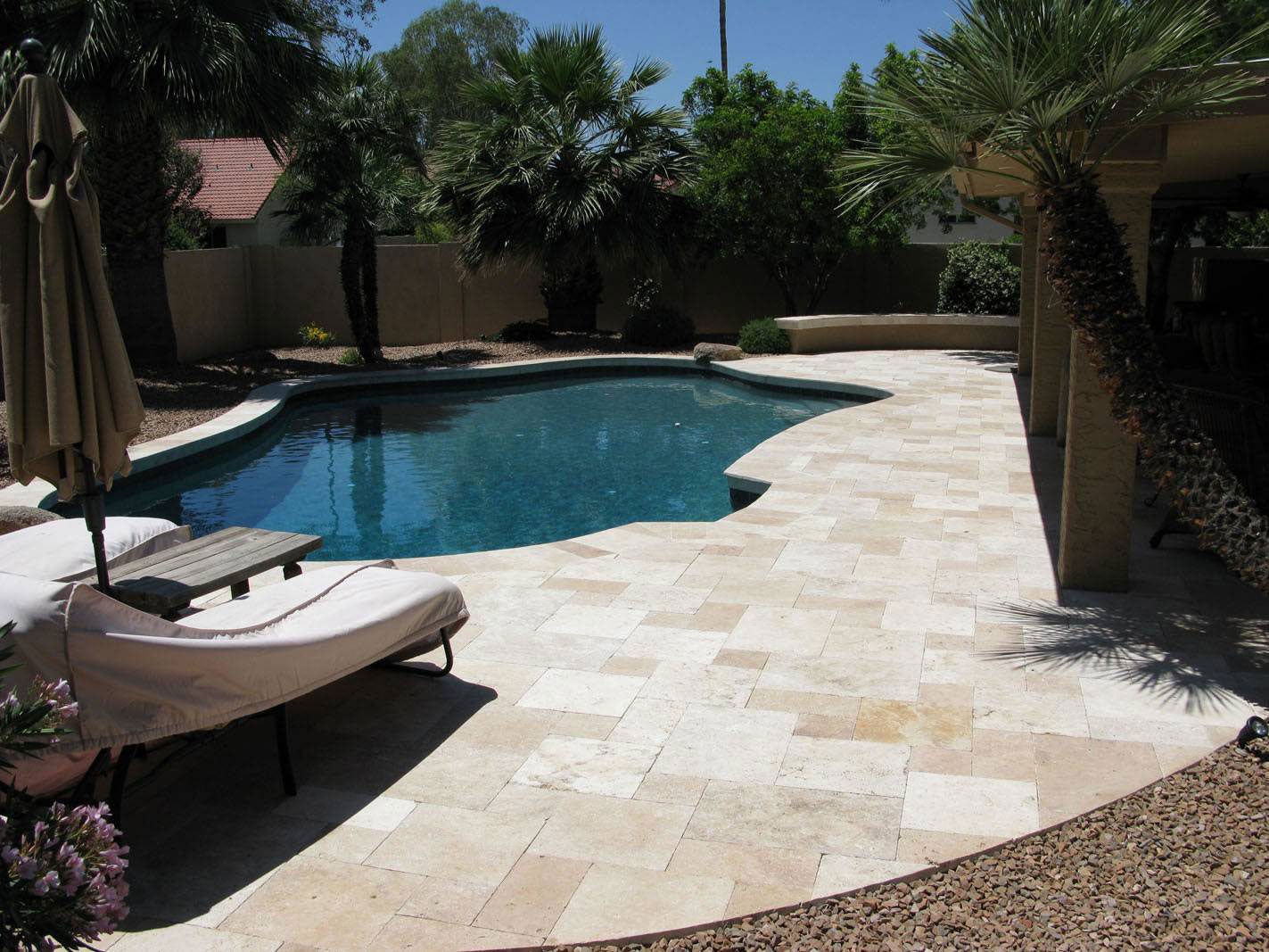 MSI-tuscany-beige-tumbled-pavers-pattern-set-pool-trees-sunbed