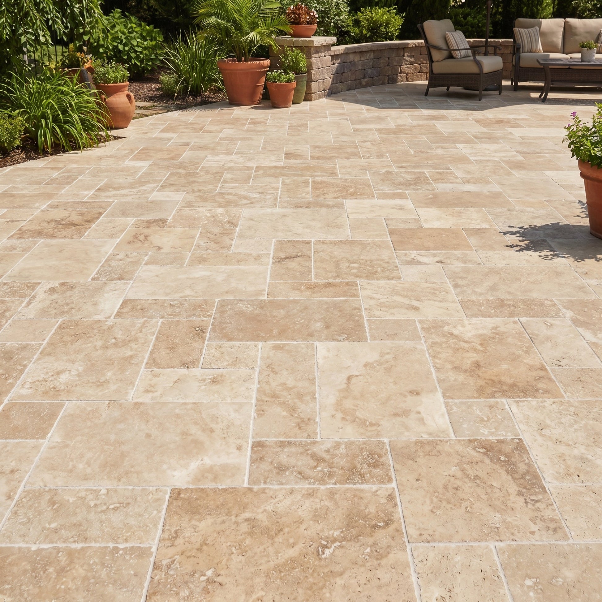 Paved patio with stone tiles, outdoor furniture, and plants in a garden setting.