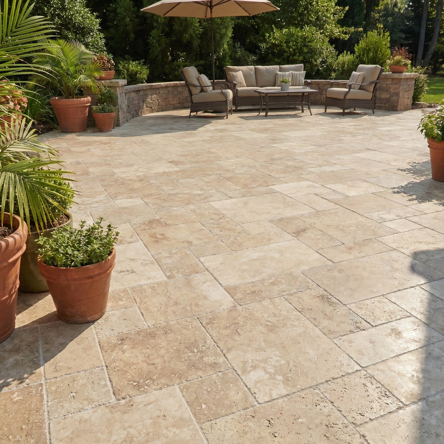 Outdoor patio with stone tiles, potted plants, and patio furniture.