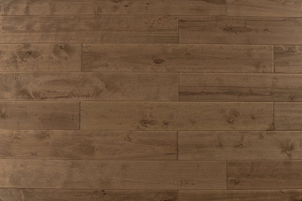 "High-quality Maple Distressed/Handscraped Solid Hardwood Flooring in a Natural Toast finish. Each plank measures 3/4 x 5 inches. SKU: TRPSH-MPNT. Enhance your space with its warm tones and exquisite texture."