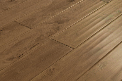 "High-quality Maple Distressed/Handscraped Solid Hardwood Flooring in a Natural Toast finish. Each plank measures 3/4 x 5 inches. SKU: TRPSH-MPNT. Enhance your space with its warm tones and exquisite texture."