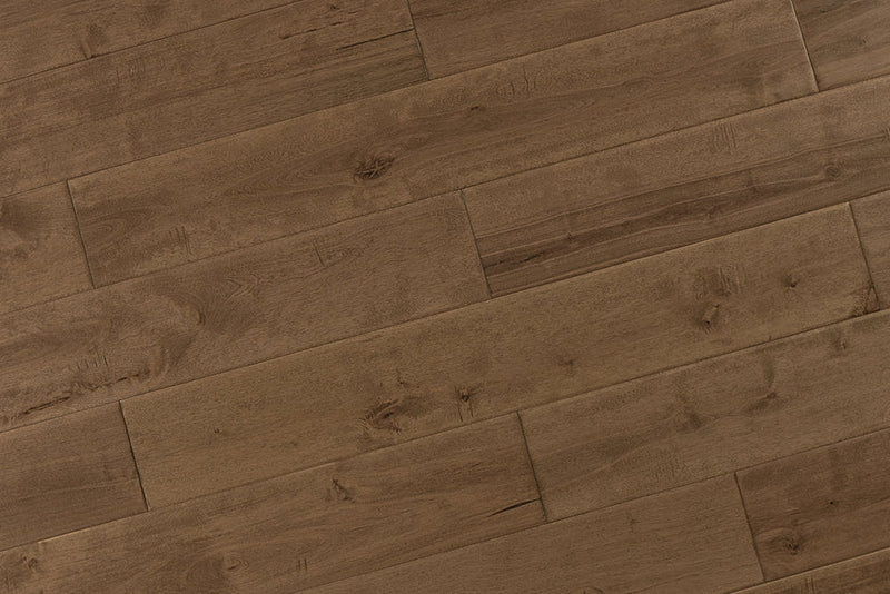 "High-quality Maple Distressed/Handscraped Solid Hardwood Flooring in a Natural Toast finish. Each plank measures 3/4 x 5 inches. SKU: TRPSH-MPNT. Enhance your space with its warm tones and exquisite texture."