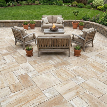 Outdoor patio with stone pavement, wooden furniture, and potted plants. Patara Beige Vein-cut Tumbled Travertine Pavers