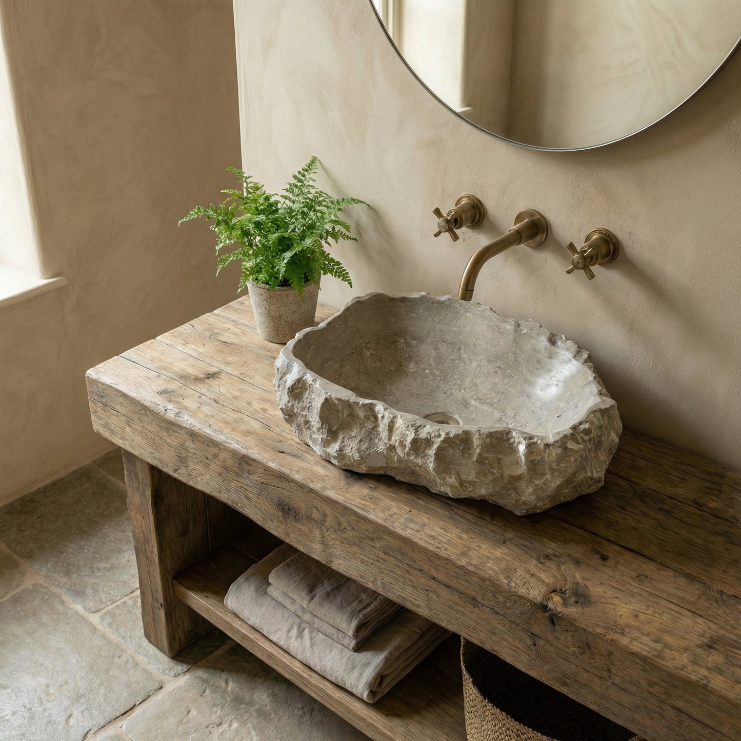 Bathroom with stone sink on wooden vanity, plant, and towels. Seagrass Fossil Limestone Rustic Natural Stone Vessel Sink (W)16" (L)20" (H)5"