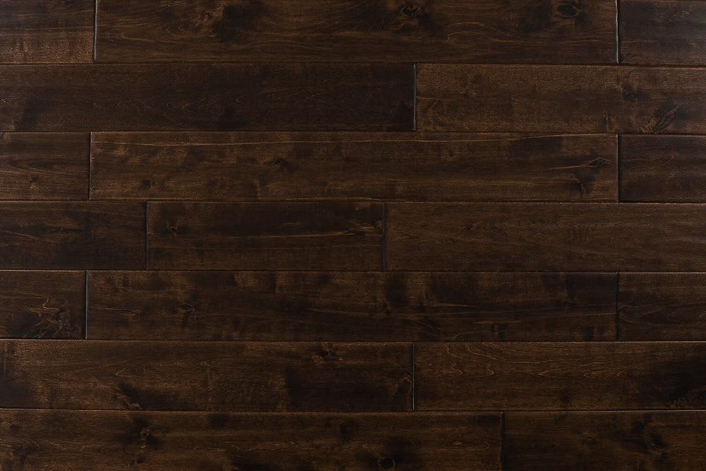 Close-up of Maple Distressed/Handscraped Solid Hardwood Flooring Planks, 3/4 x 5 inches, in a rich Walnut finish, showcasing its natural texture and warmth.