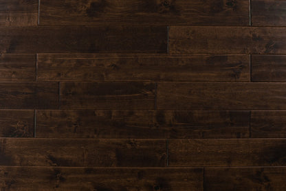 Close-up of Maple Distressed/Handscraped Solid Hardwood Flooring Planks, 3/4 x 5 inches, in a rich Walnut finish, showcasing its natural texture and warmth.