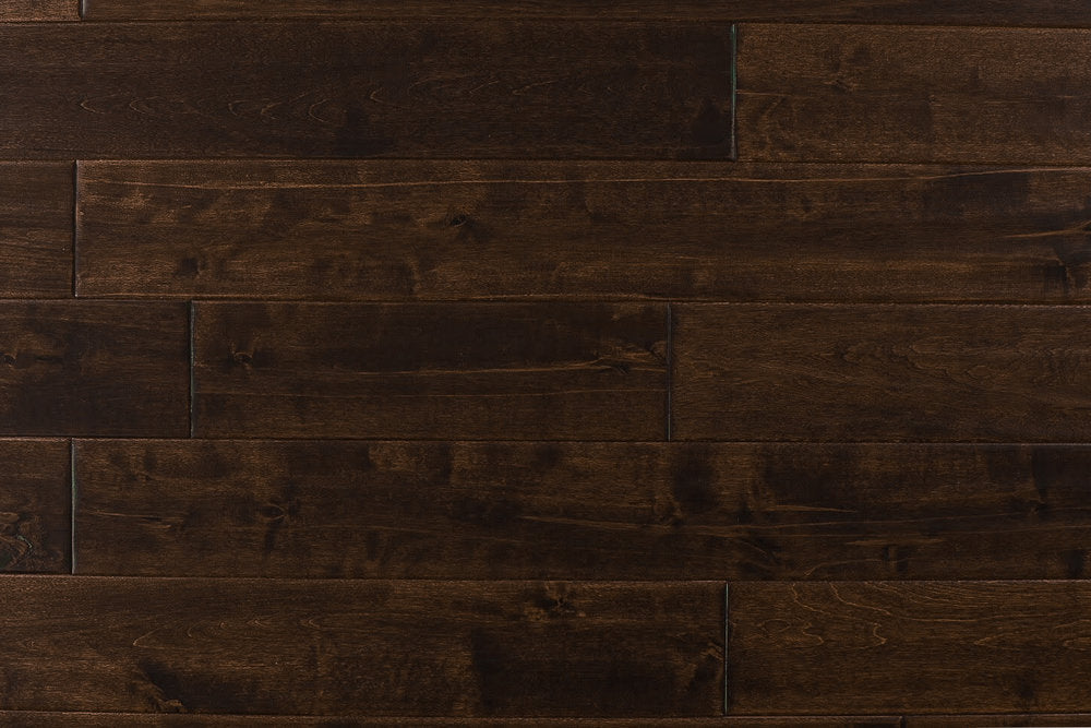 Close-up of Maple Distressed/Handscraped Solid Hardwood Flooring Planks, 3/4 x 5 inches, in a rich Walnut finish, showcasing its natural texture and warmth.