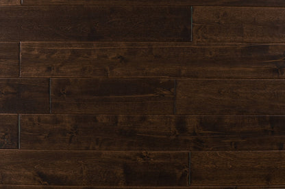 Close-up of Maple Distressed/Handscraped Solid Hardwood Flooring Planks, 3/4 x 5 inches, in a rich Walnut finish, showcasing its natural texture and warmth.