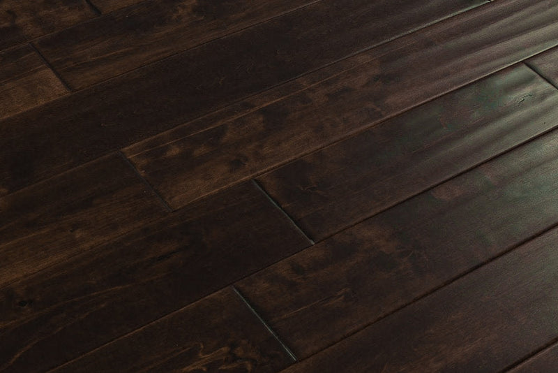 Close-up of Maple Distressed/Handscraped Solid Hardwood Flooring Planks, 3/4 x 5 inches, in a rich Walnut finish, showcasing its natural texture and warmth.