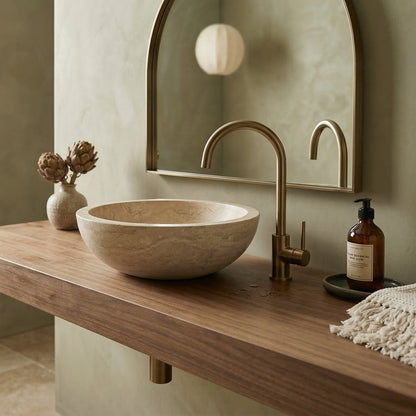 Bathroom vanity with stone sink, bronze faucet, and decorative items. Beige Travertine Natural Stone Vessel Sink Honed and Filled  (D)16" (H)6"