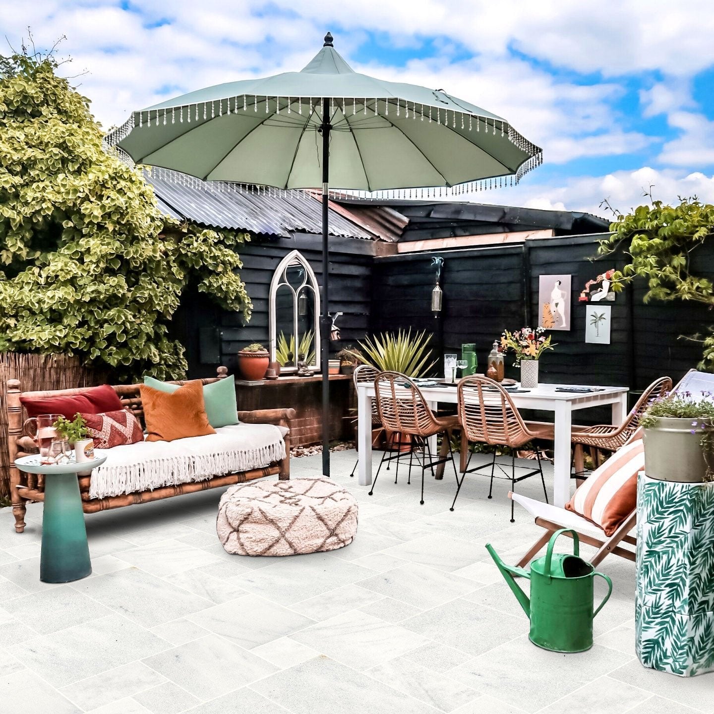 Outdoor patio with furniture, umbrella, and plants on a sunny day. Turkish Carrara White Marble Sand-Blasted Pavers