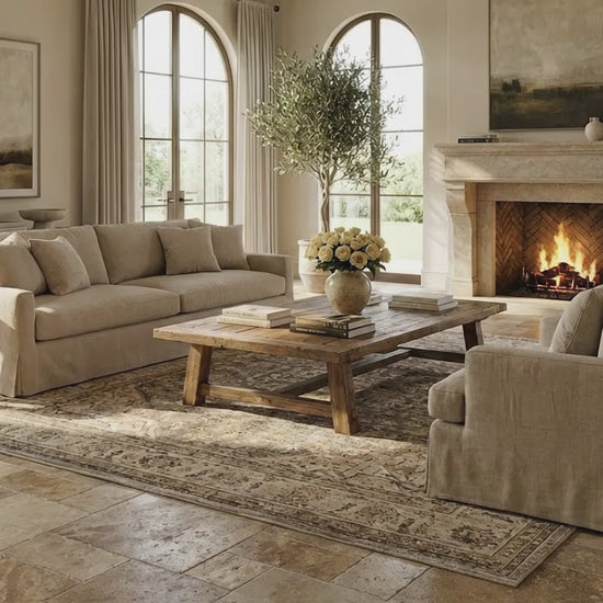 Cozy living room with beige sofa, wooden coffee table, and fireplace. Meandros walnut antique pattern set travertine tile SKU-10061703 multi top view
