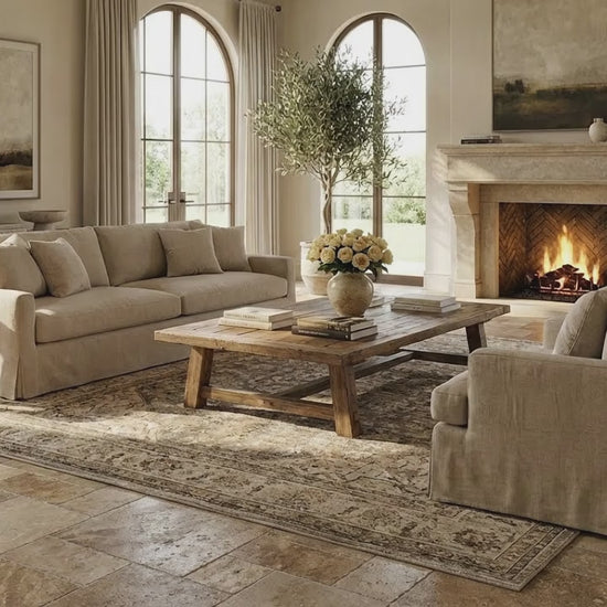Cozy living room with beige sofa, wooden coffee table, and fireplace. Meandros walnut antique pattern set travertine tile SKU-10061703 multi top view