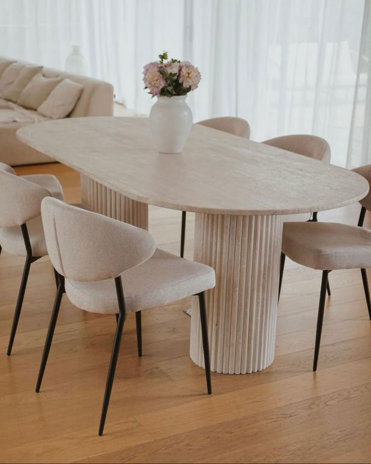 Troia Light Travertine Oval Dining Table with Fluted Round Legs (W)40" (L)75" (H)30" living room view beige color chairs wooden floors